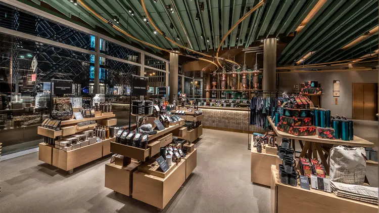 Display tables with a variety of products, including coffee, drinkware, brewing equipment and apparel