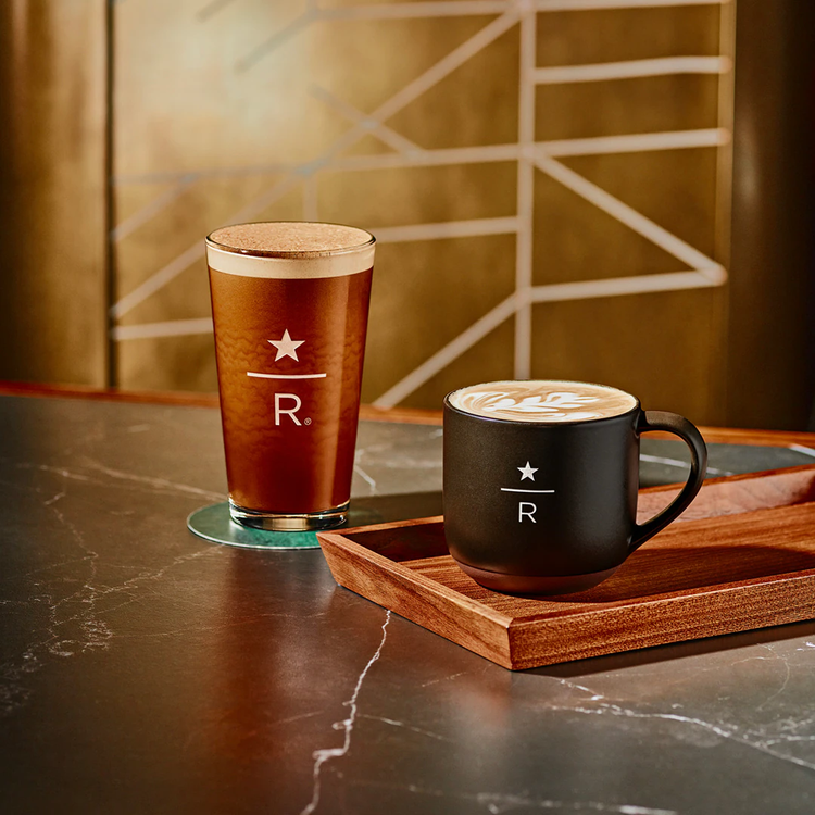 Two coffee beverages on a counter.